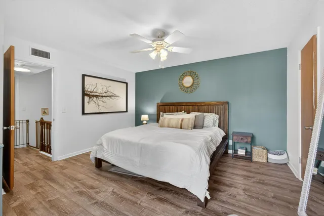 a bedroom with a large bed a flat screen tv and a couch