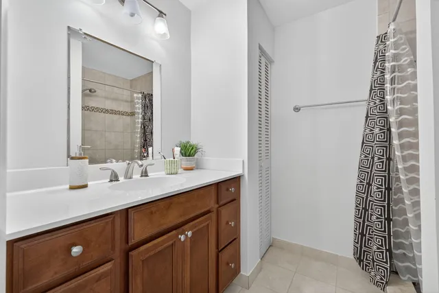 a spacious bathroom with a granite countertop sink a mirror and a