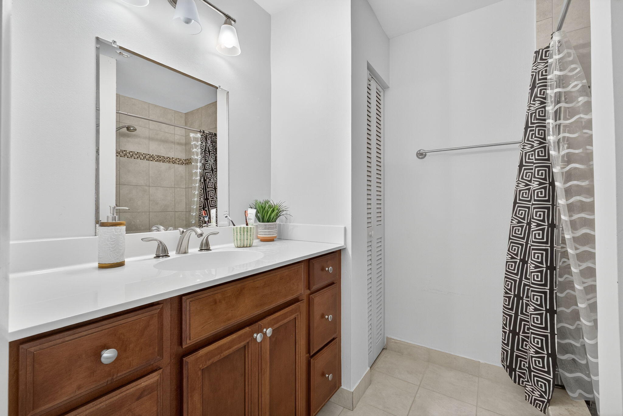 326 Jupiter Lakes Boulevard, Unit 2310C Jupiter, FL 33458 - Photo 37 of 46 a bathroom with a shower sink and vanity