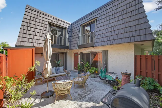 a backyard of a house with outdoor seating
