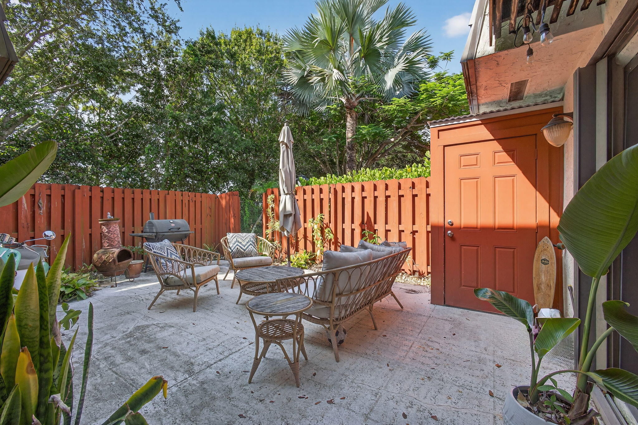 326 Jupiter Lakes Boulevard, Unit 2310C Jupiter, FL 33458 - Photo 10 of 46 a backyard of a house with table and chairs