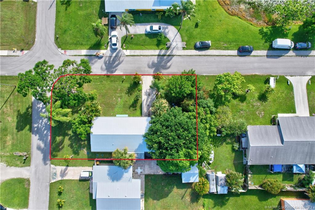 4651 Southeast Chatham Avenue Stuart, FL 34997 - Photo 13 of 49 an aerial view of a house with a garden and swimming pool