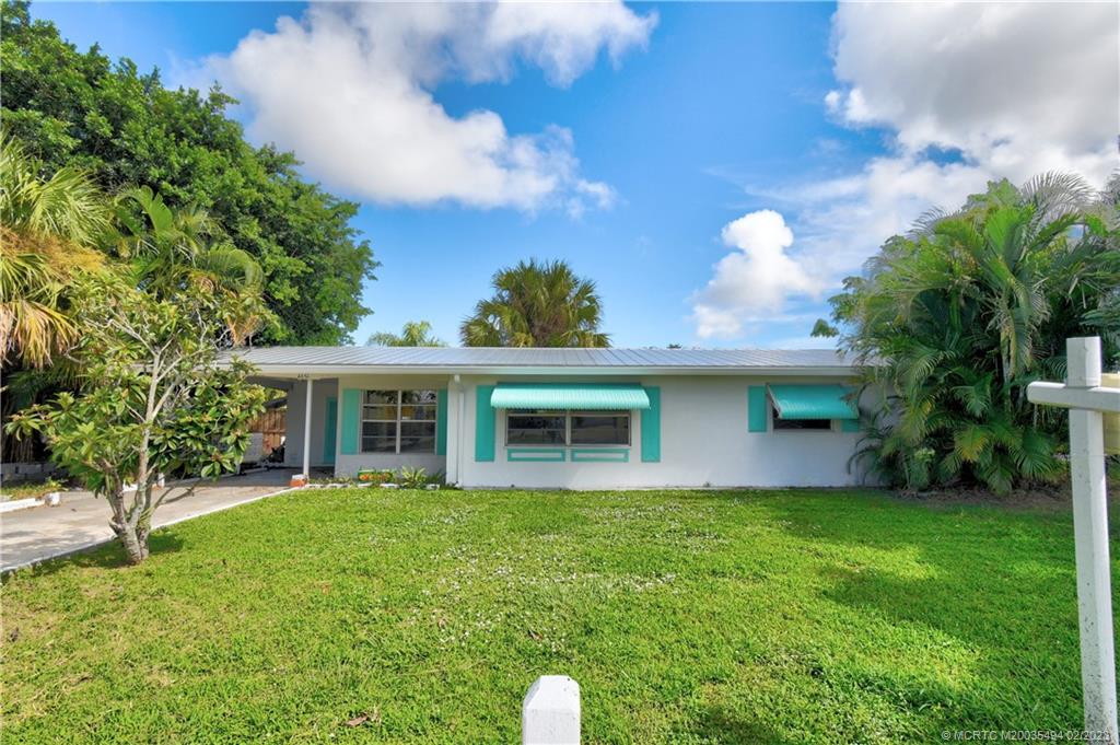 4651 Southeast Chatham Avenue Stuart, FL 34997 - Photo 20 of 49 a view of a house with a yard potted plants and a tree