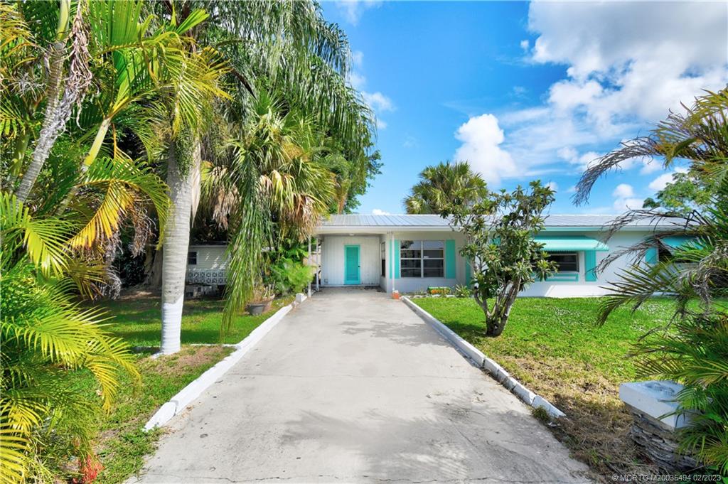 4651 Southeast Chatham Avenue Stuart, FL 34997 - Photo 21 of 49 a front view of a house with garden