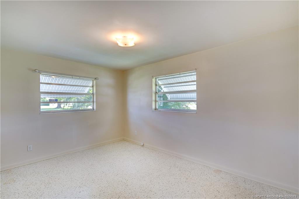 4651 Southeast Chatham Avenue Stuart, FL 34997 - Photo 49 of 49 an empty room with windows
