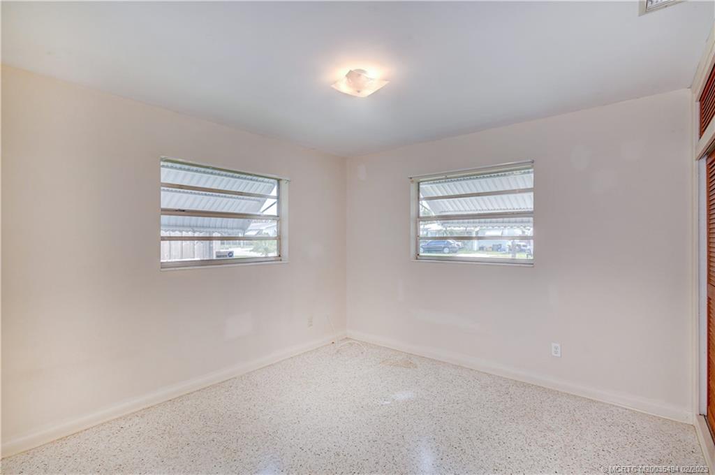 4651 Southeast Chatham Avenue Stuart, FL 34997 - Photo 6 of 49 an empty room with windows