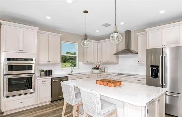 a kitchen with refrigerator cabinets and wooden floor