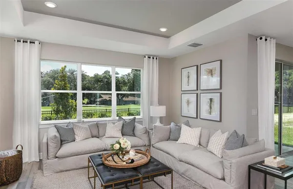 a living room with furniture and a large window