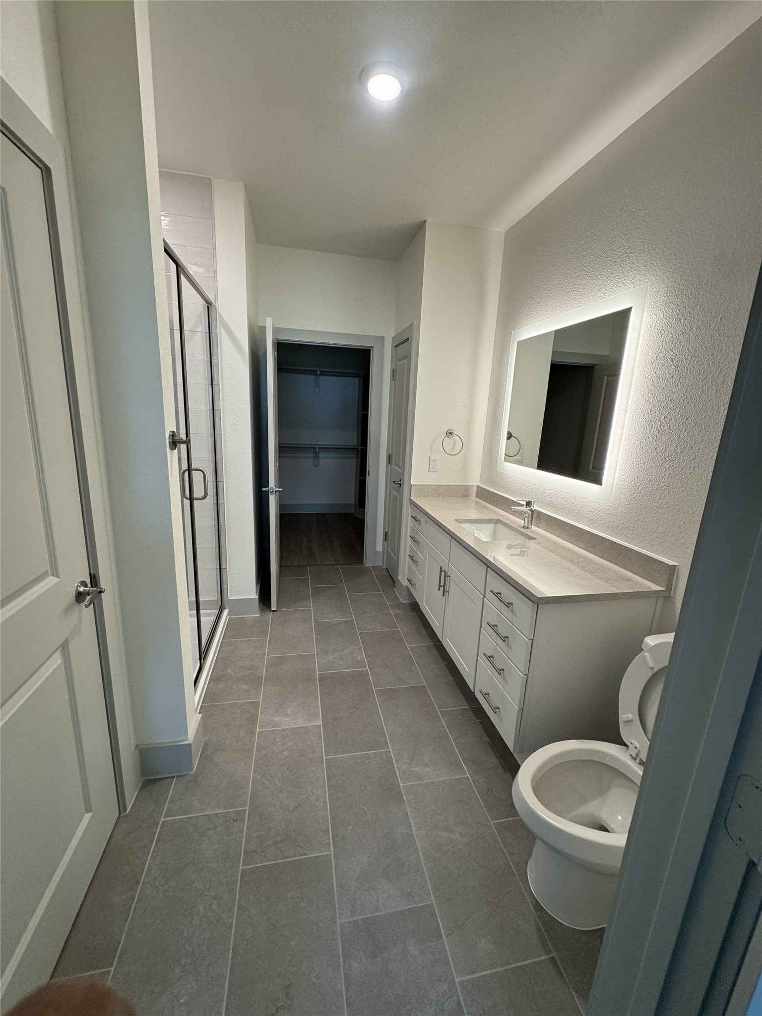 26244 Twin Oaks Road Splendora, TX 77372 - Photo 7 of 10 a bathroom with a toilet sink and mirror