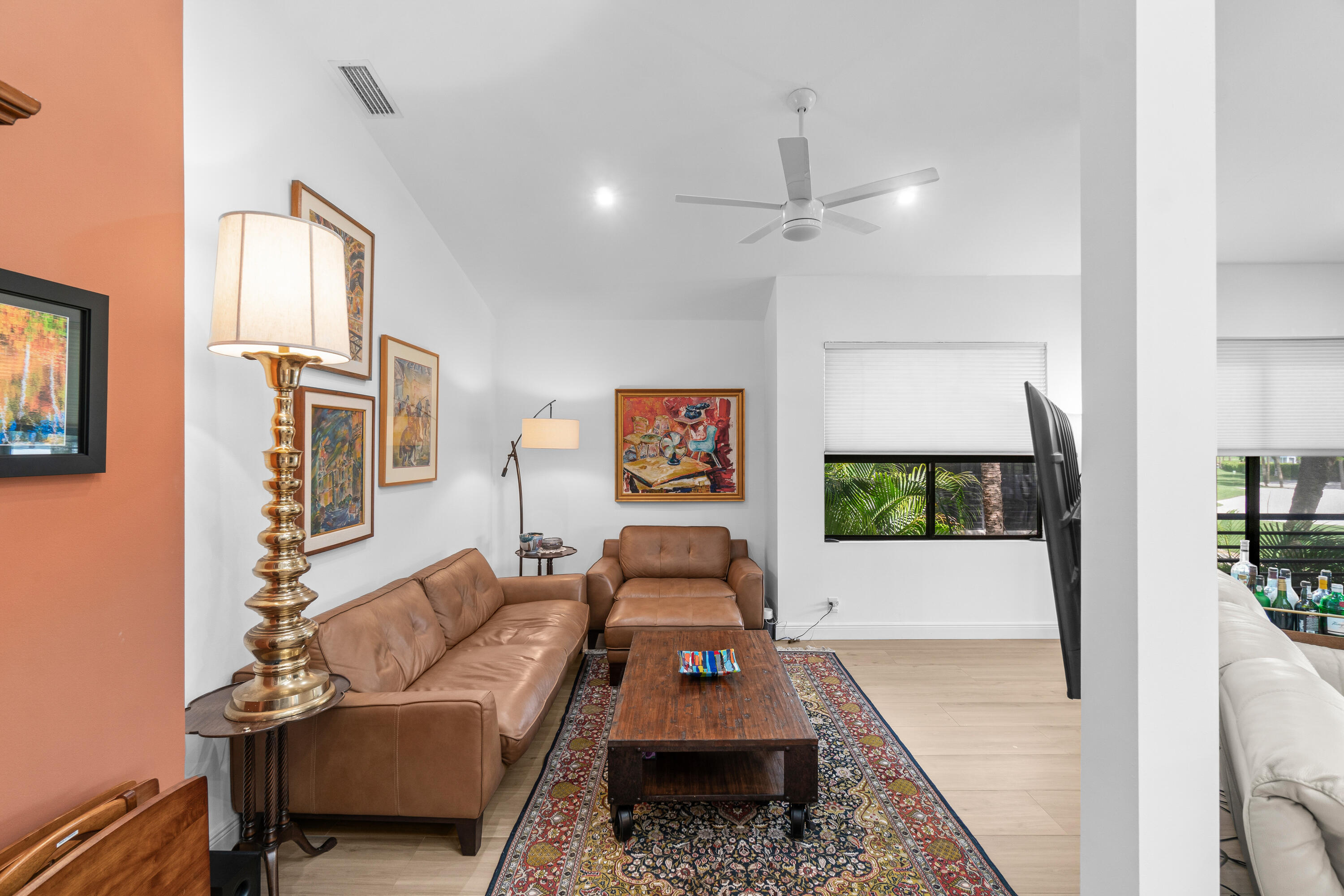 17557 Ashbourne Lane, Unit B Boca Raton, FL 33496 - Photo 12 of 41 a living room with furniture and a flat screen tv