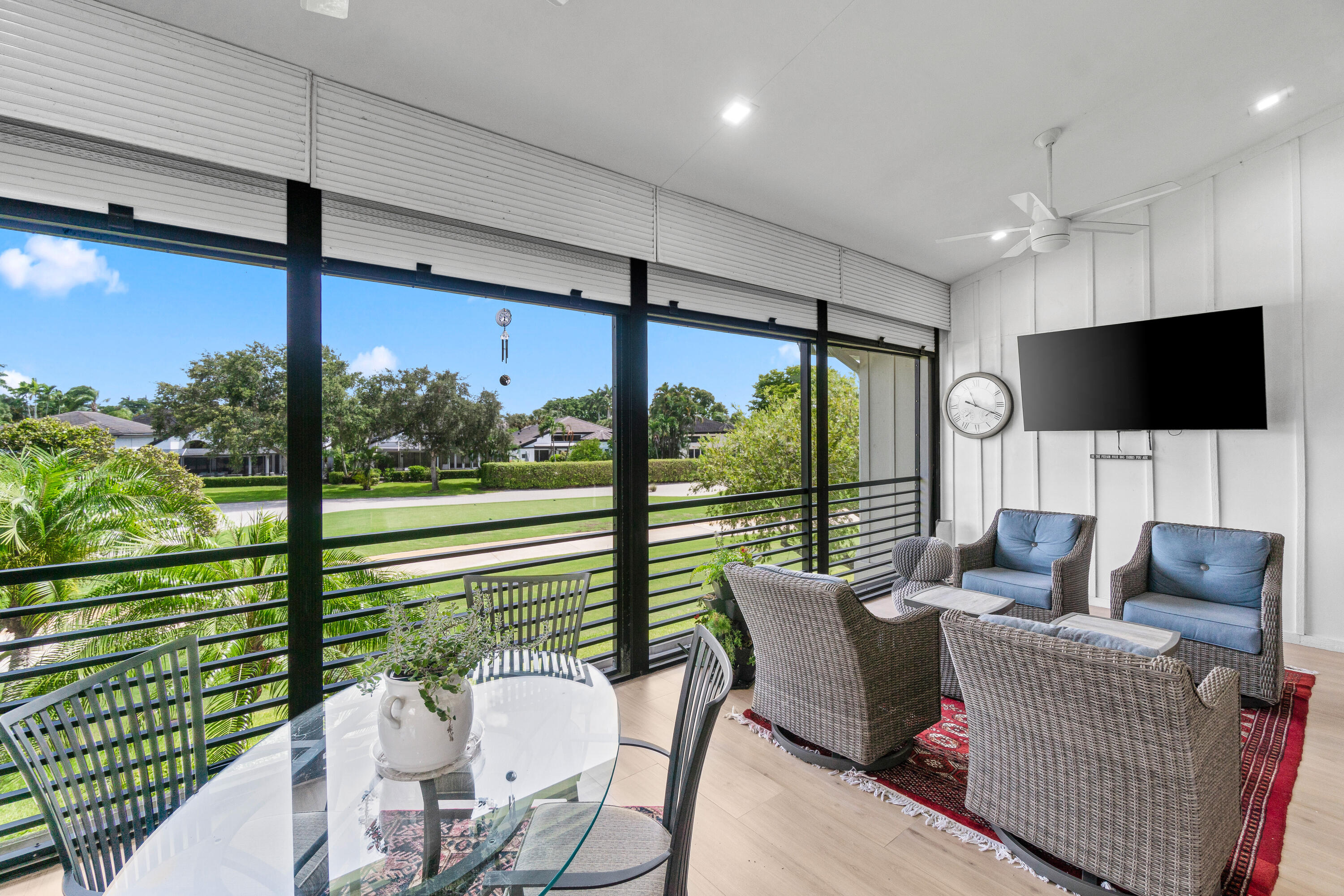 17557 Ashbourne Lane, Unit B Boca Raton, FL 33496 - Photo 15 of 41 a living room with furniture tv and large windows