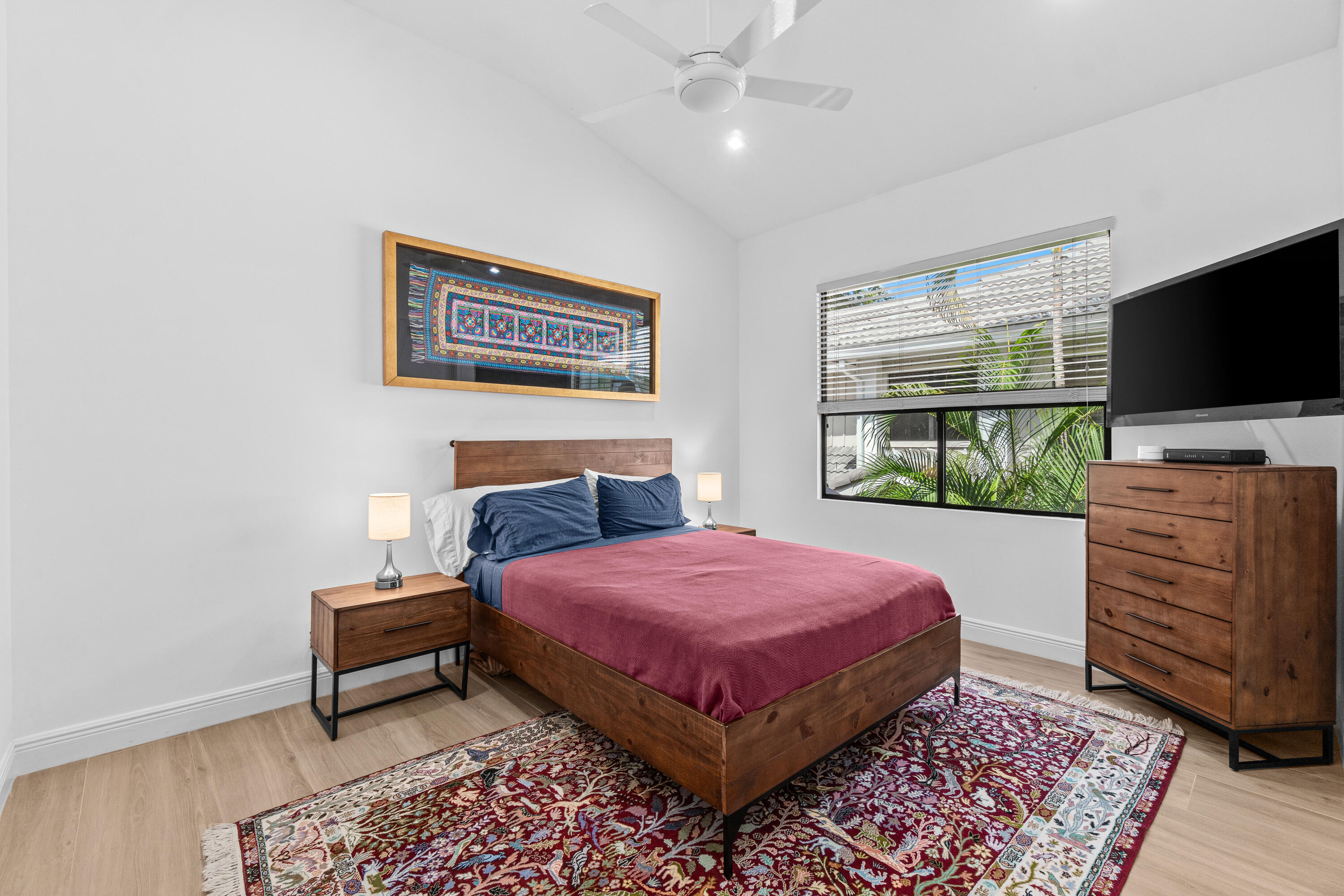 17557 Ashbourne Lane, Unit B Boca Raton, FL 33496 - Photo 25 of 41 a bedroom with a bed and a flat screen tv