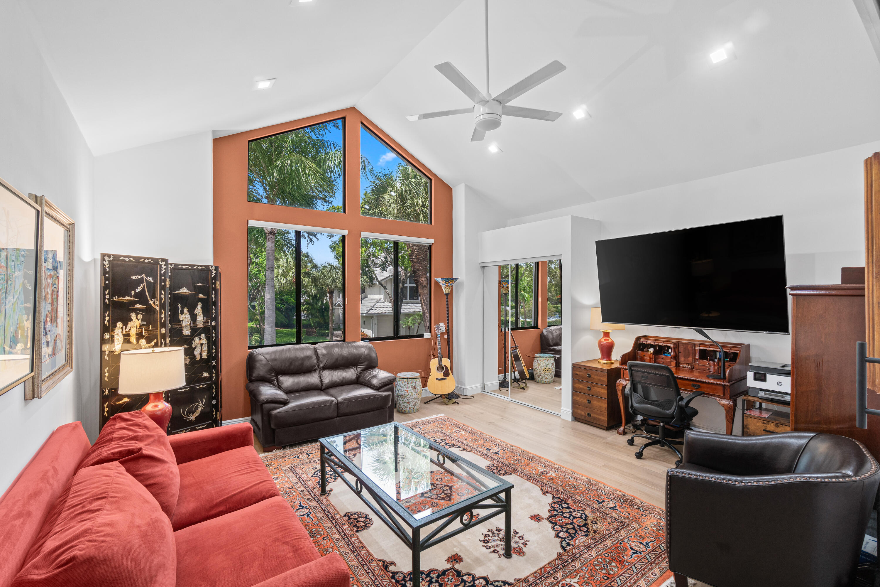 17557 Ashbourne Lane, Unit B Boca Raton, FL 33496 - Photo 29 of 41 a living room with furniture a flat screen tv and a large window