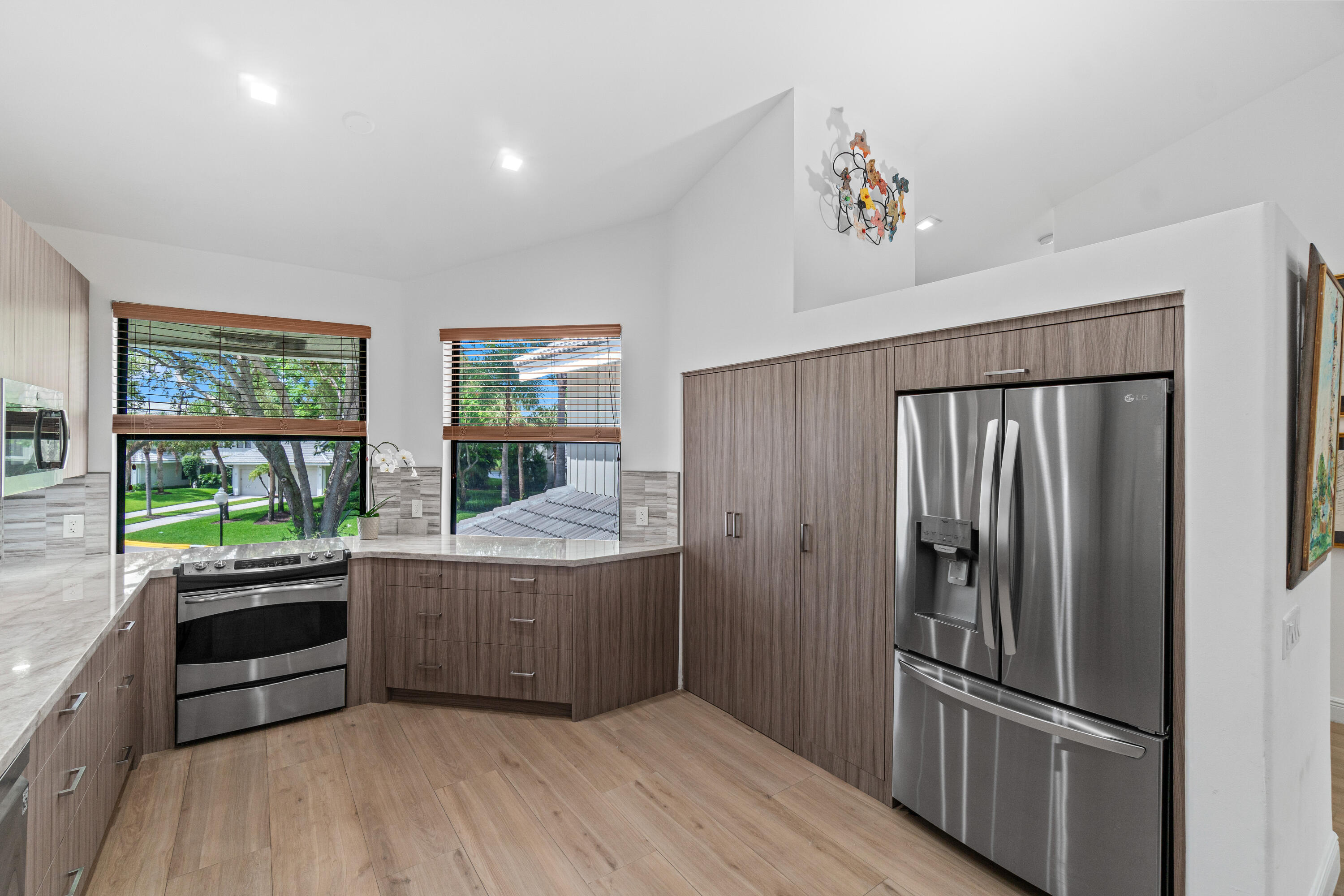 17557 Ashbourne Lane, Unit B Boca Raton, FL 33496 - Photo 3 of 41 a kitchen with stainless steel appliances granite countertop a refrigerator and a sink