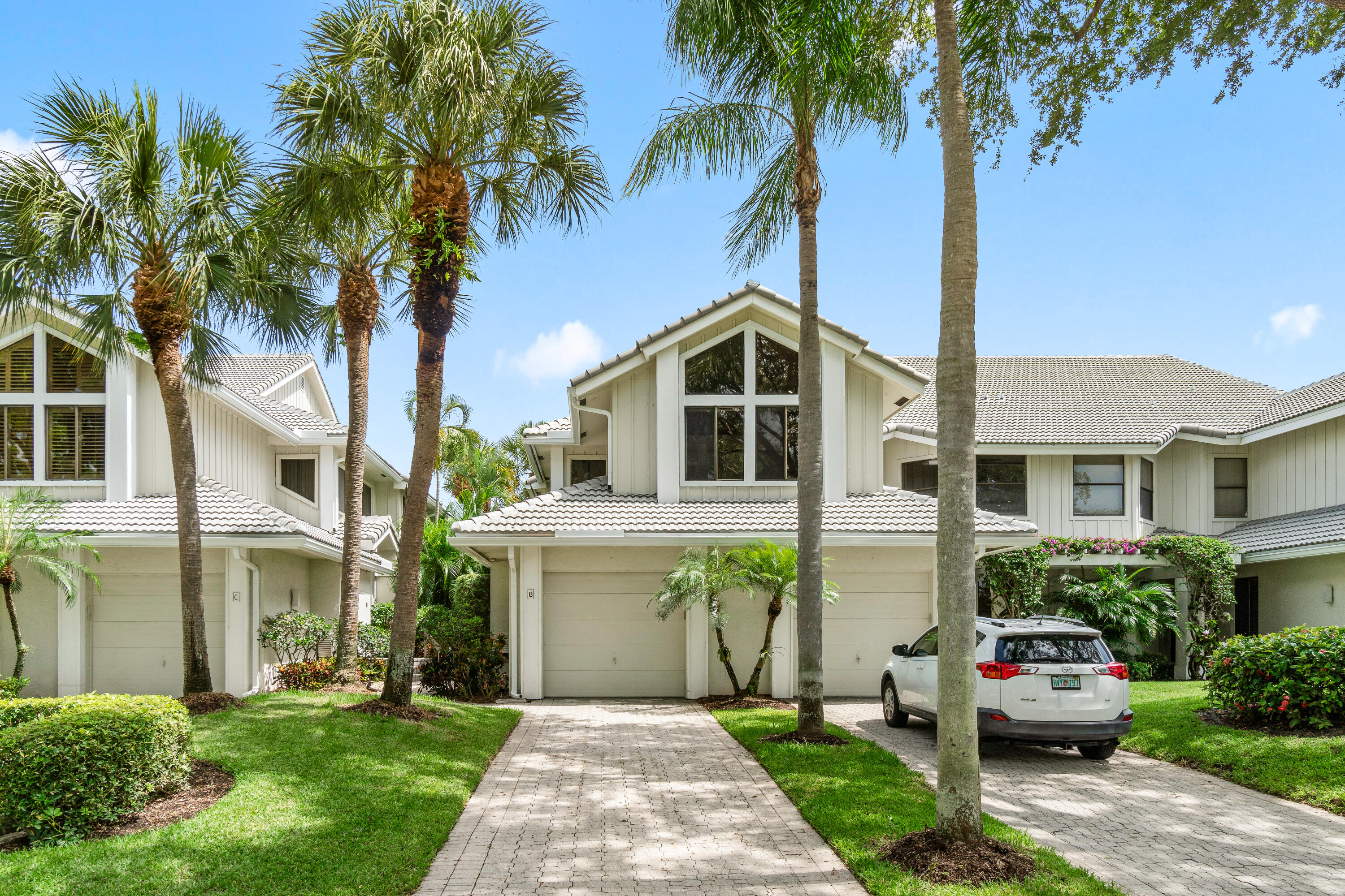 17557 Ashbourne Lane, Unit B Boca Raton, FL 33496 - Photo 39 of 41 a front view of a house with a garden