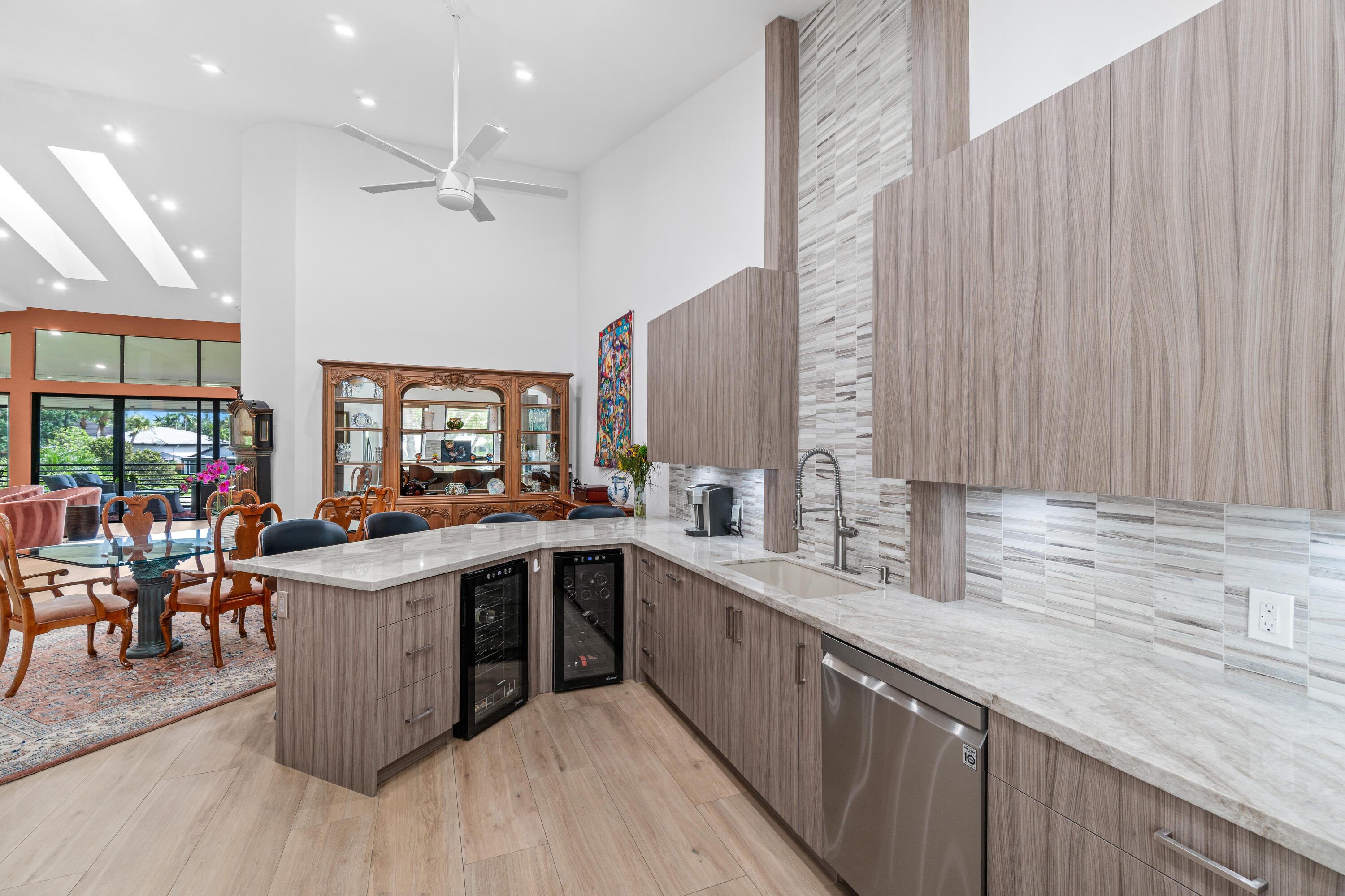 17557 Ashbourne Lane, Unit B Boca Raton, FL 33496 - Photo 4 of 41 a kitchen with lots of counter space a sink appliances and a large window