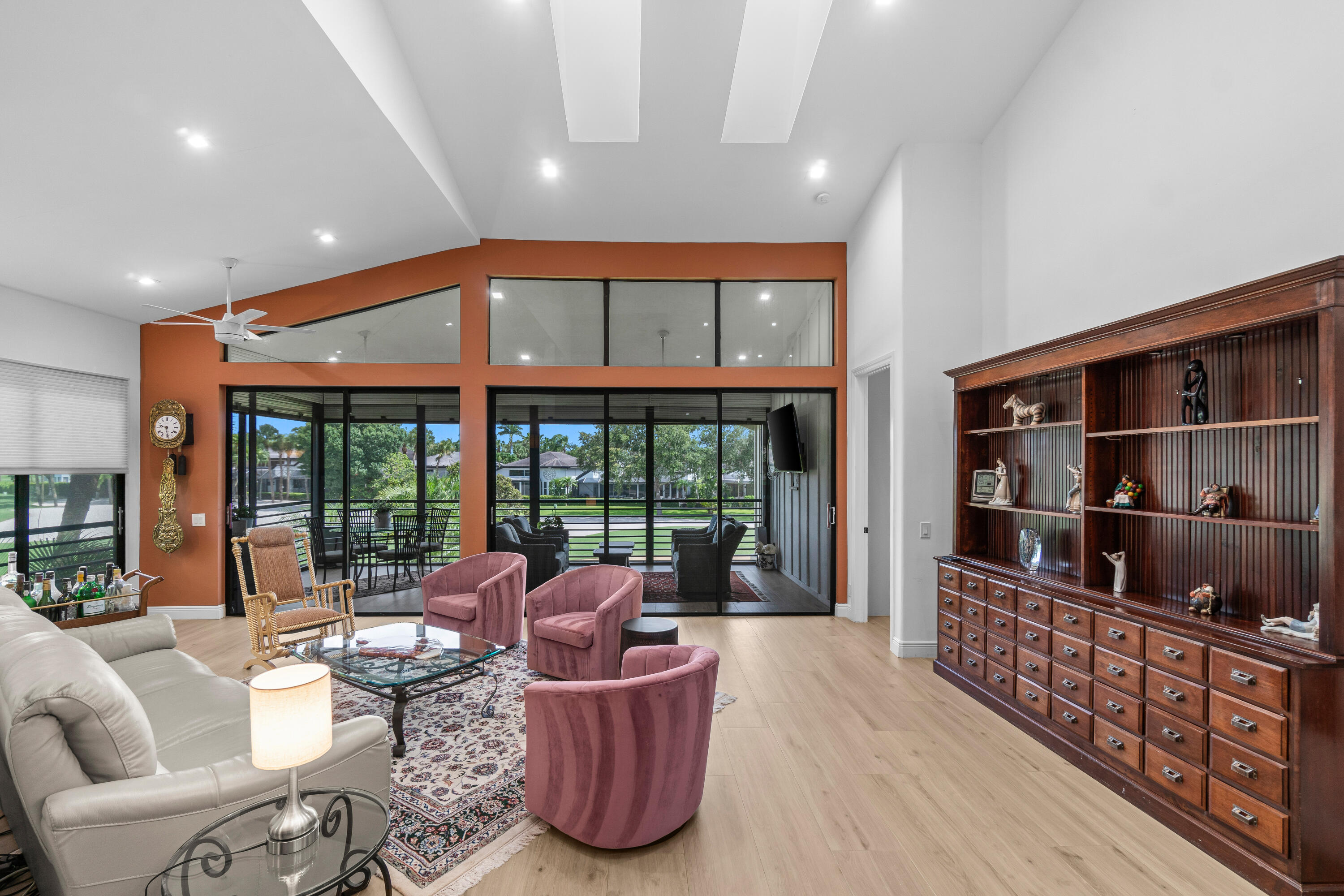 17557 Ashbourne Lane, Unit B Boca Raton, FL 33496 - Photo 9 of 41 a living room with furniture a window and bookshelf