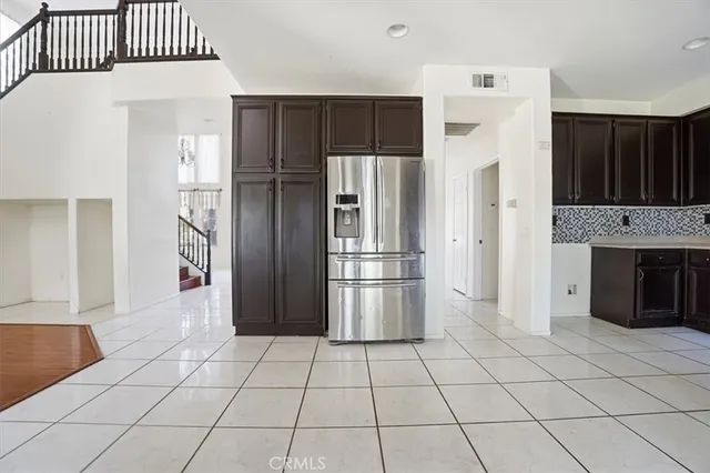 a kitchen with stainless steel appliances granite countertop a refrigerator and a stove top oven