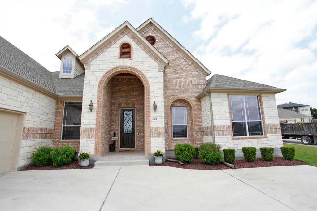 a front view of a house with garden