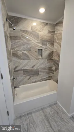 a bathroom with a bathtub and a shower