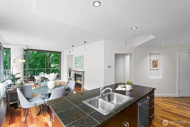 a dining room with furniture a large window and a fireplace