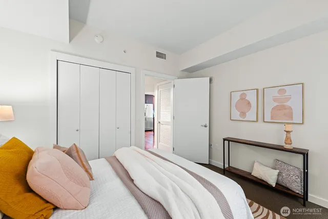 a bathroom with a granite countertop sink a toilet and a mirror