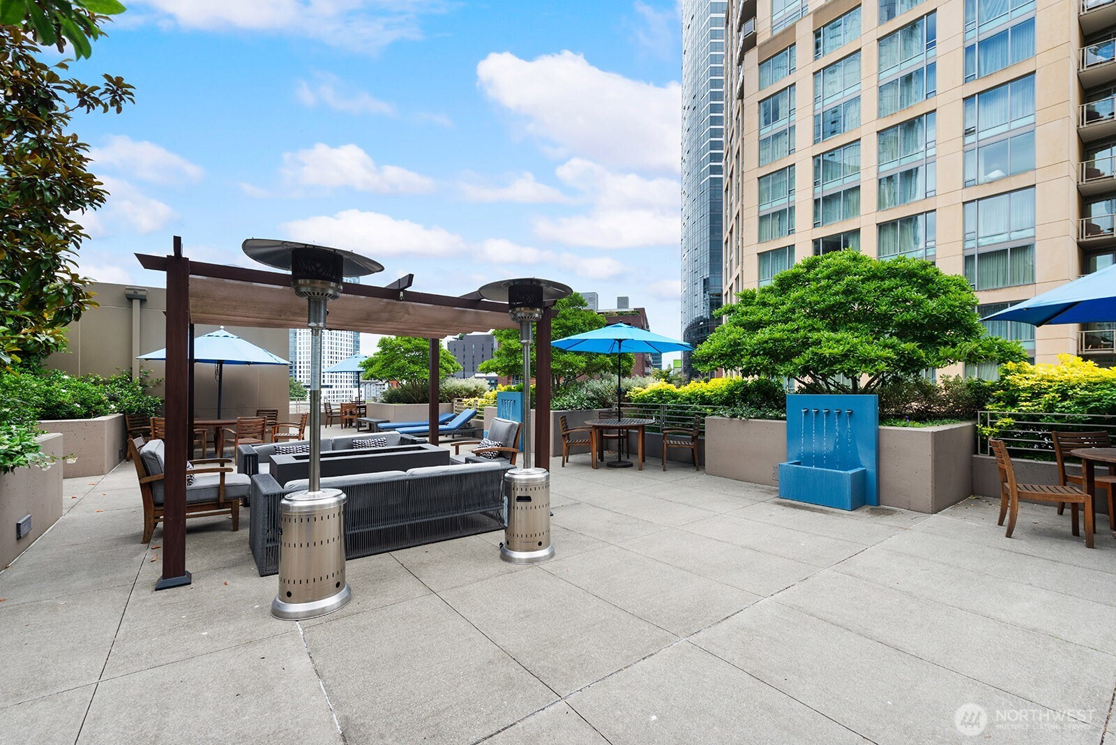 910 Lenora Street, Unit S403 Seattle, WA 98121 - Photo 33 of 40 a view of a patio with dining table and chairs potted plants
