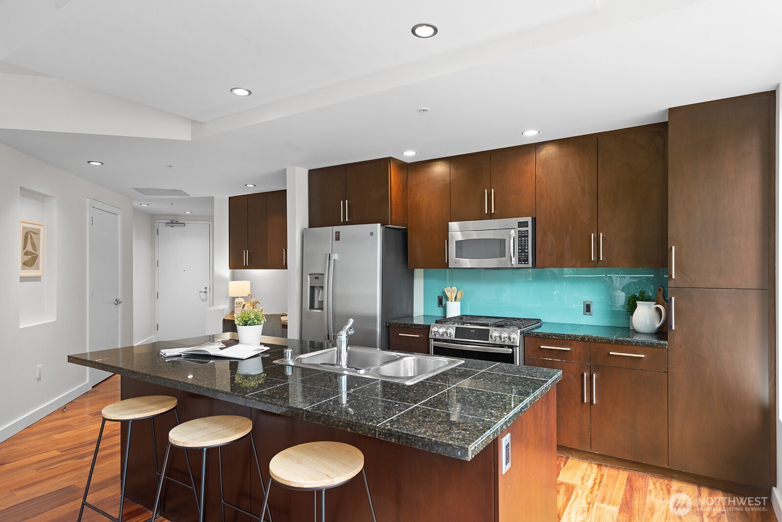 910 Lenora Street, Unit S403 Seattle, WA 98121 - Photo 7 of 40 a kitchen with stainless steel appliances granite countertop a sink refrigerator and microwave