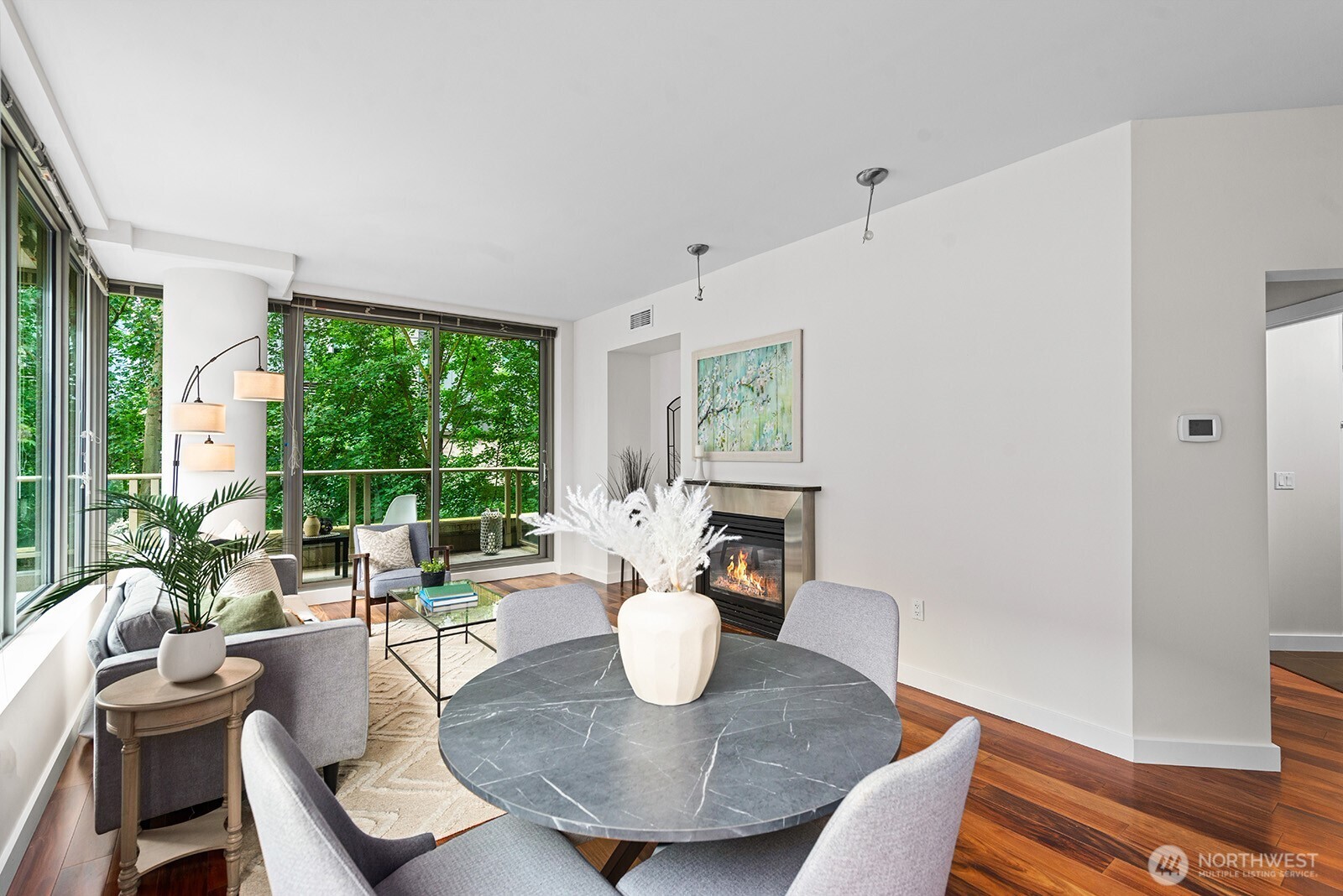 910 Lenora Street, Unit S403 Seattle, WA 98121 - Photo 10 of 40 a view of a dining room with furniture wooden floor and a potted plant