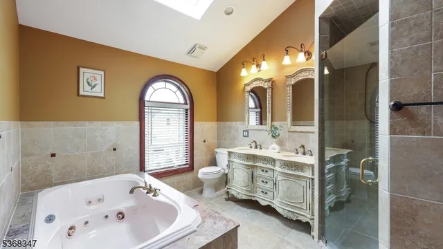 a bathroom with a tub sink and mirror