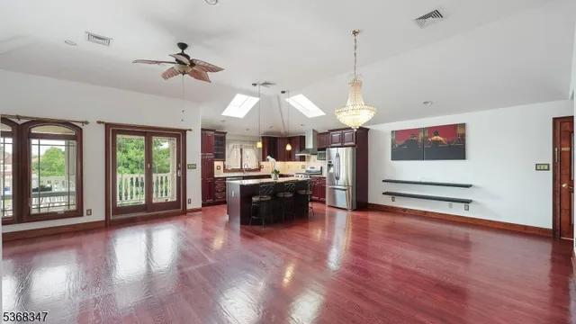 a view of a room with kitchen island and wooden floor