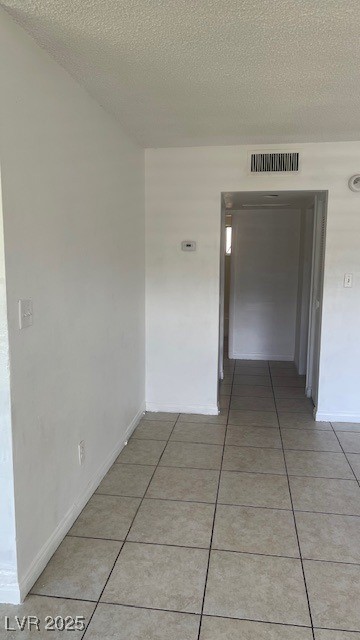 350 East Desert Inn Road, Unit B103 Las Vegas, NV 89109 - Photo 18 of 25 Hall featuring light tile patterned floors and a textured ceiling