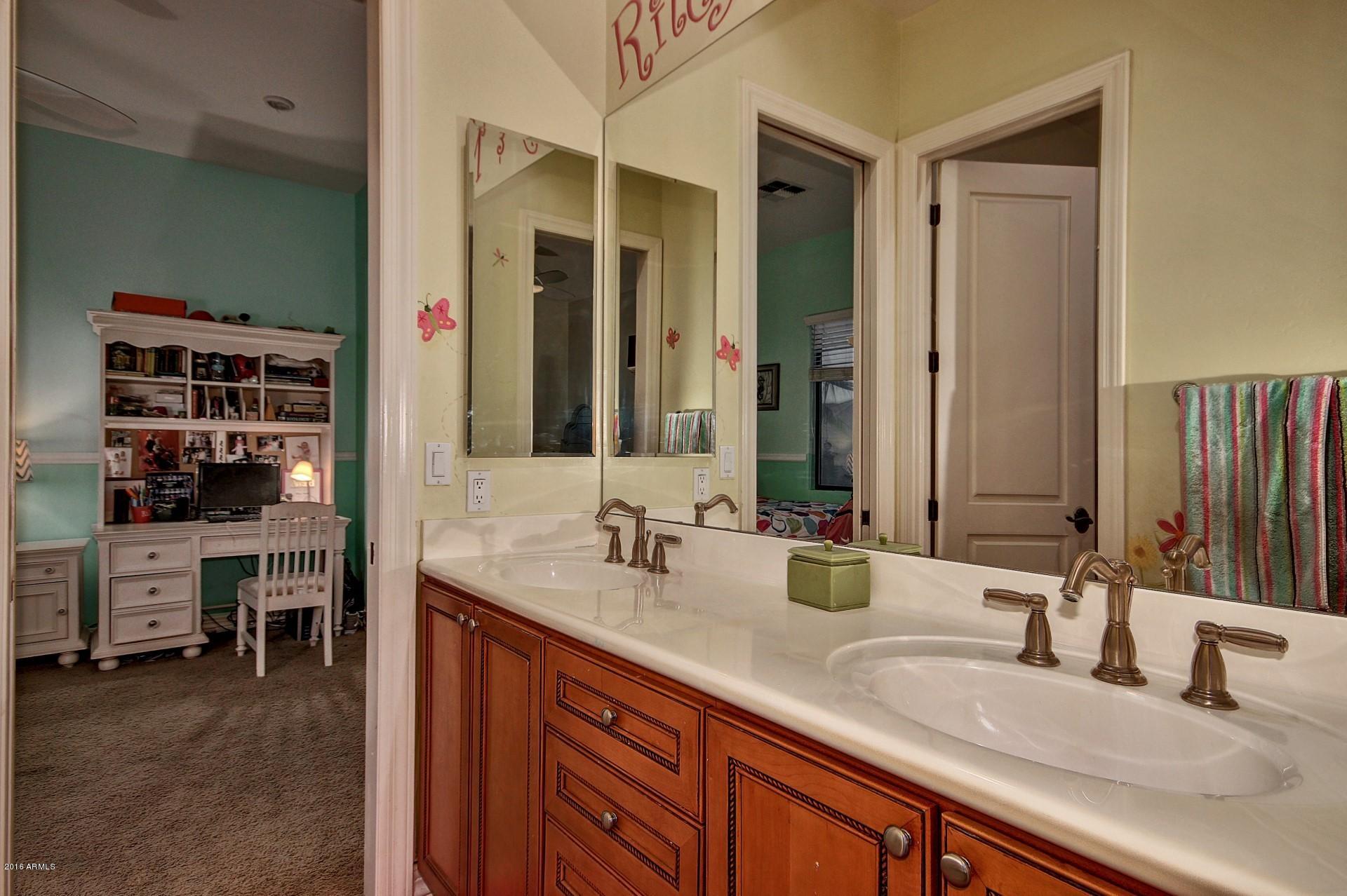 16417 South 23rd Way Phoenix, AZ 85048 - Photo 12 of 32 a bathroom with a double vanity sink and a mirror