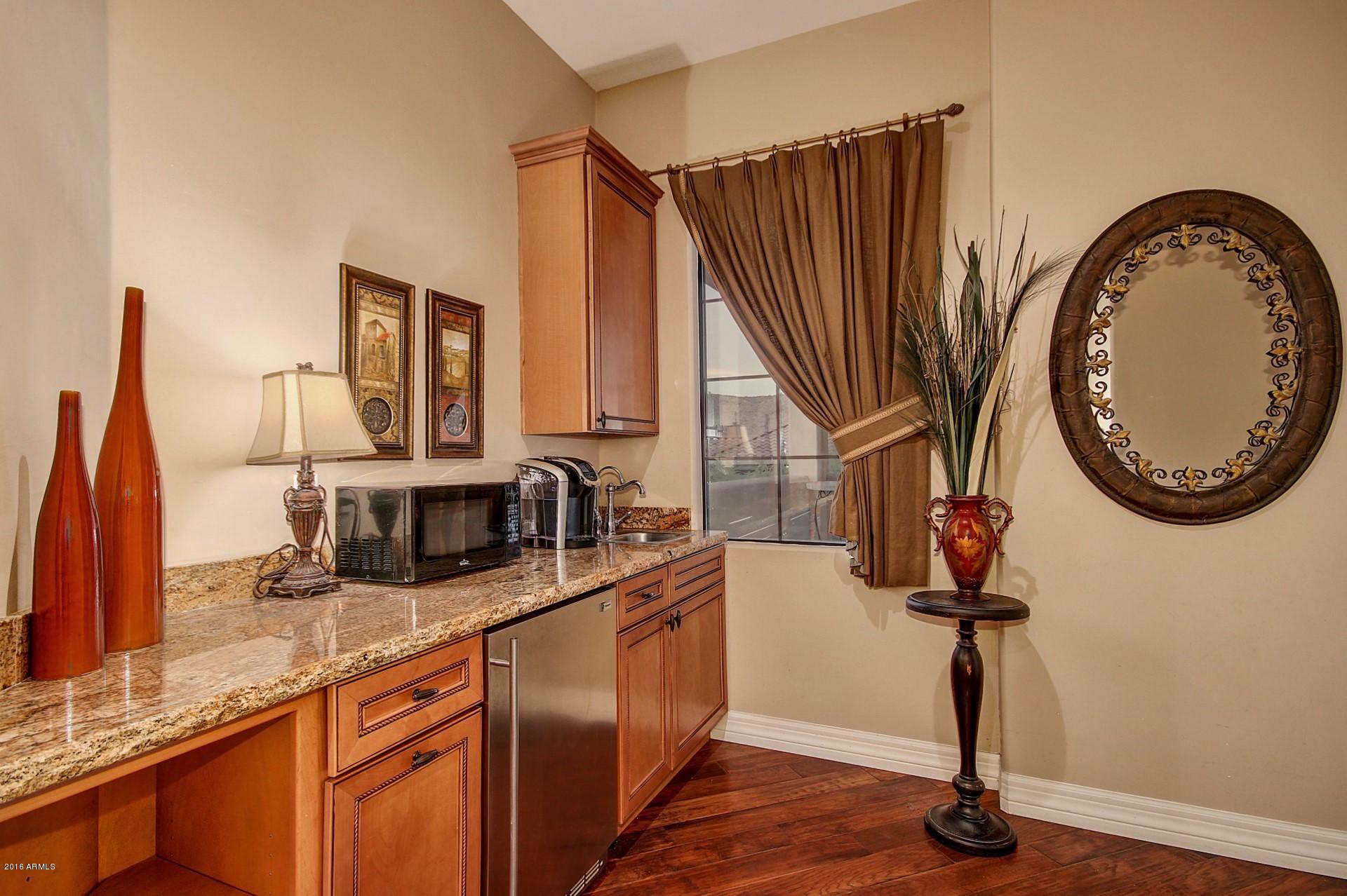 16417 South 23rd Way Phoenix, AZ 85048 - Photo 16 of 32 a kitchen with stainless steel appliances granite countertop a sink a stove and a wooden floors