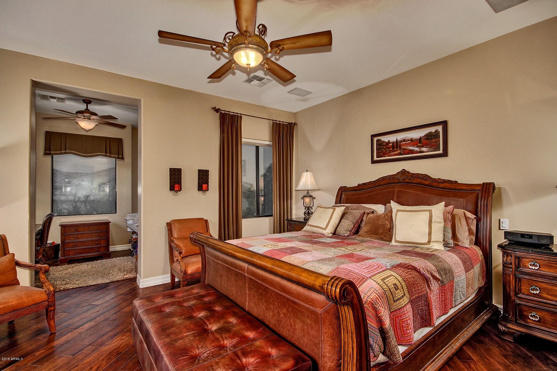 16417 South 23rd Way Phoenix, AZ 85048 - Photo 17 of 32 a bedroom with a bed and a chandelier