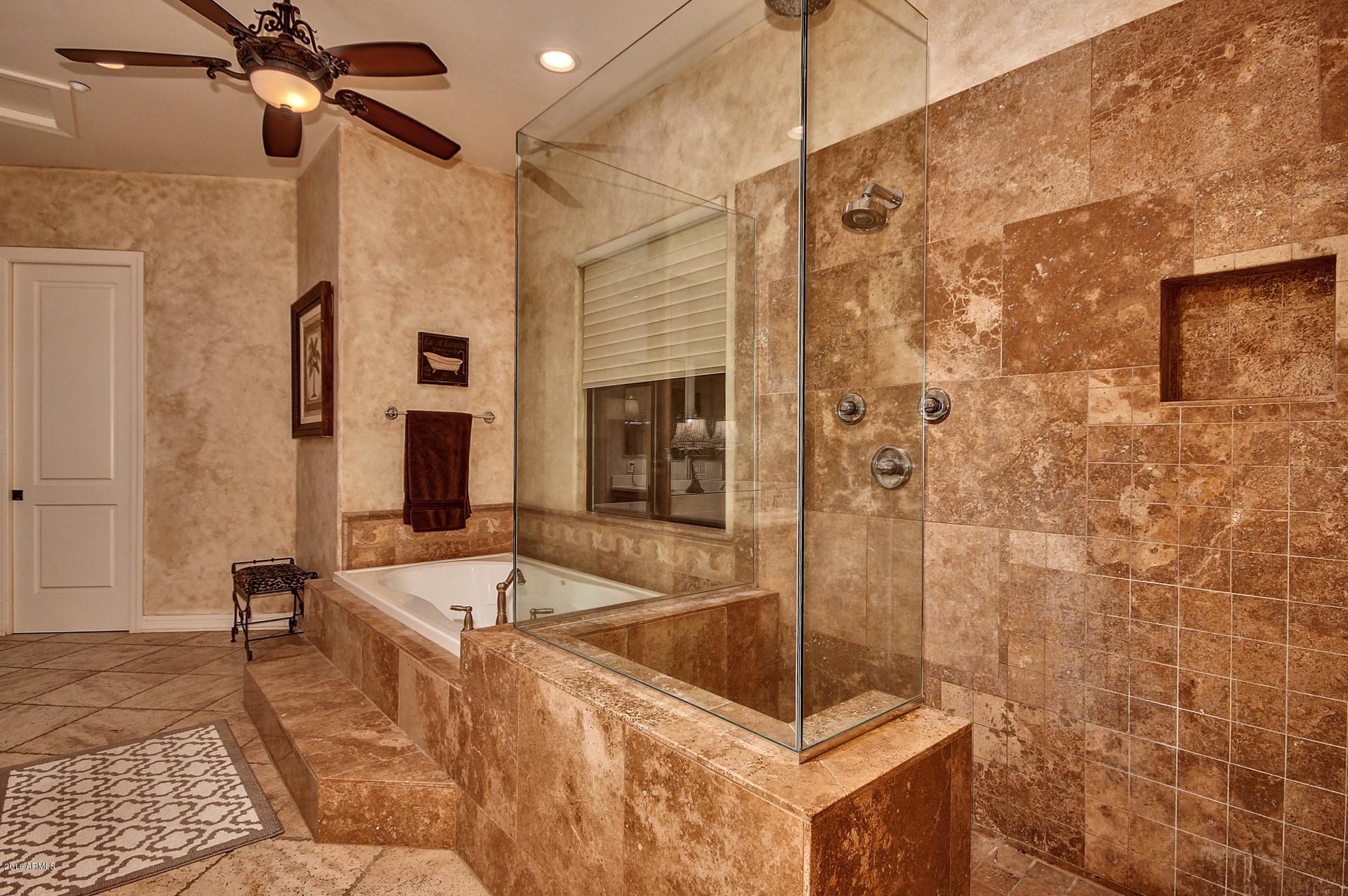 16417 South 23rd Way Phoenix, AZ 85048 - Photo 20 of 32 a bathroom with a tub a mirror and shower