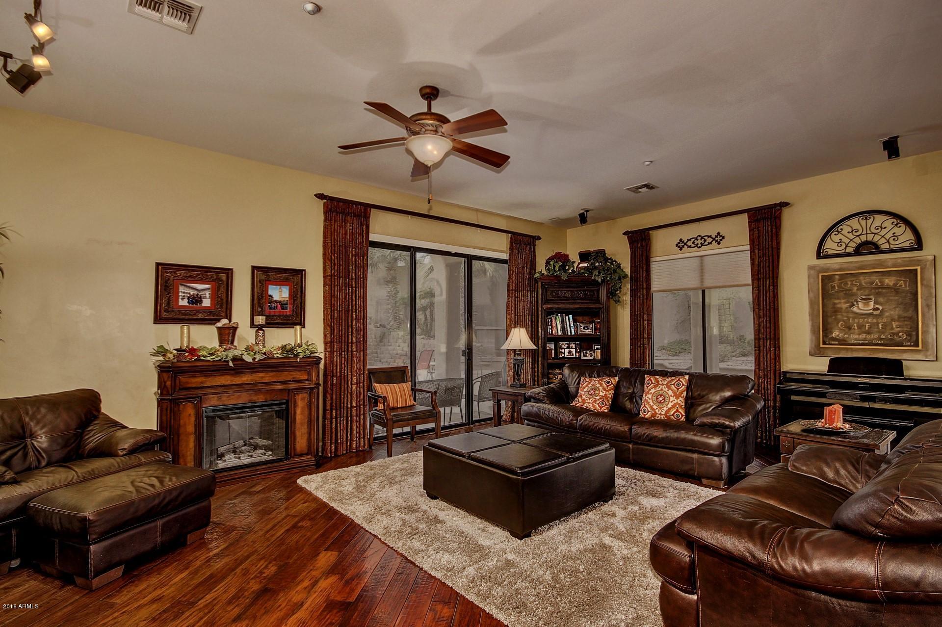 16417 South 23rd Way Phoenix, AZ 85048 - Photo 4 of 32 a living room with furniture and a fireplace