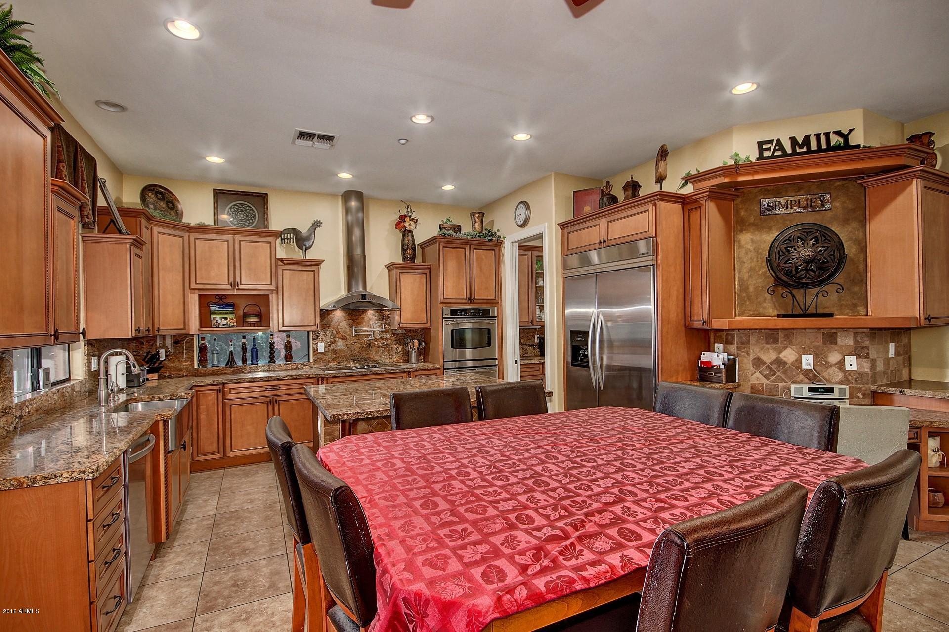 16417 South 23rd Way Phoenix, AZ 85048 - Photo 5 of 32 a kitchen with a stove a sink and a refrigerator