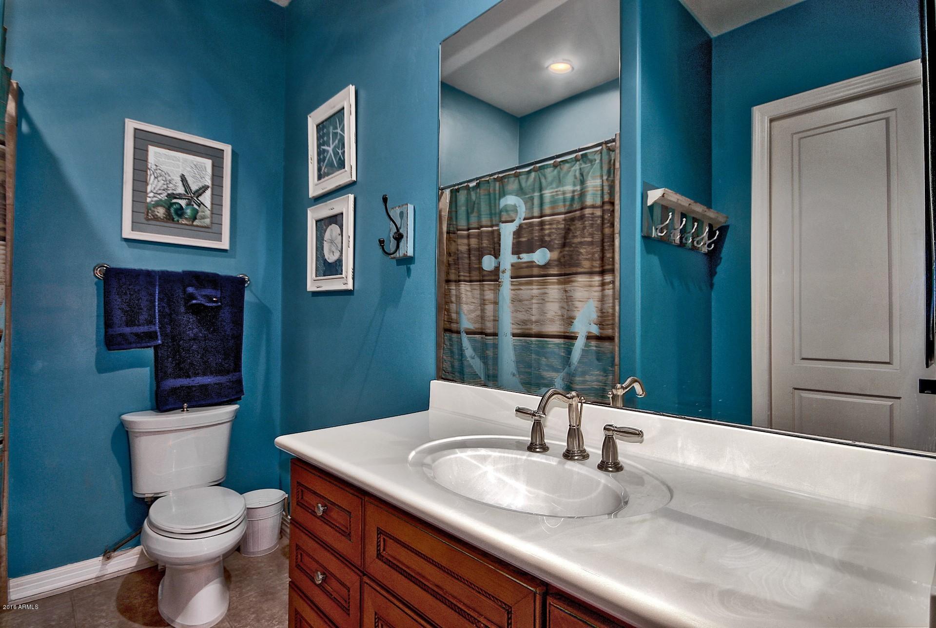 16417 South 23rd Way Phoenix, AZ 85048 - Photo 7 of 32 a bathroom with a toilet a sink and mirror