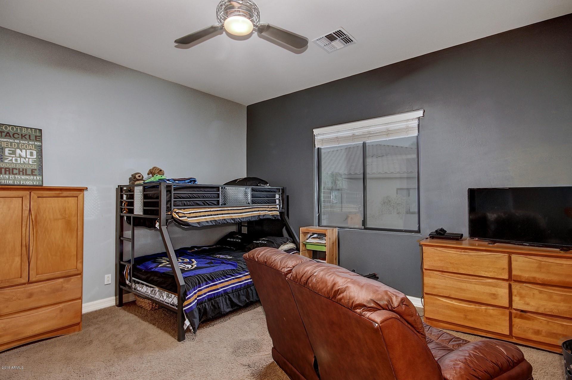 16417 South 23rd Way Phoenix, AZ 85048 - Photo 8 of 32 a bedroom with furniture and flat screen tv