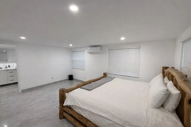 a bedroom with a bed and a night stand