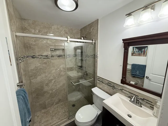 a bathroom with a sink toilet and shower