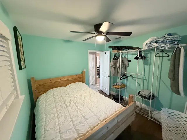 a bedroom with a bed and a mirror