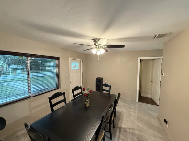 a view of a dining room with furniture window and outside view