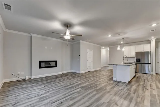 a view of a hallway with wooden floor and staircase