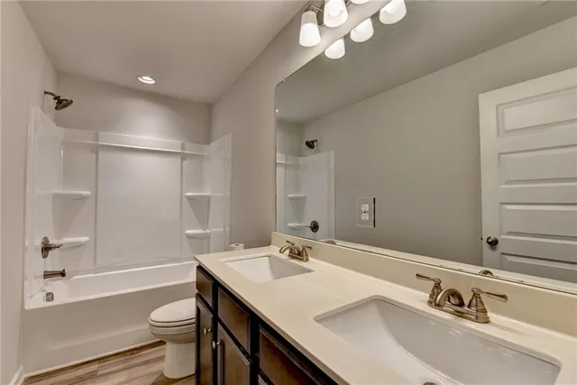 a bathroom with a double vanity sink and a mirror