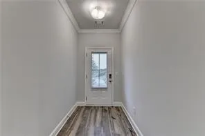 a view of empty room with wooden floor