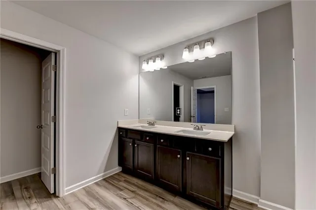 a view of swimming pool with lawn chairs and plants