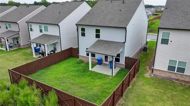 an aerial view of a house with a swimming pool