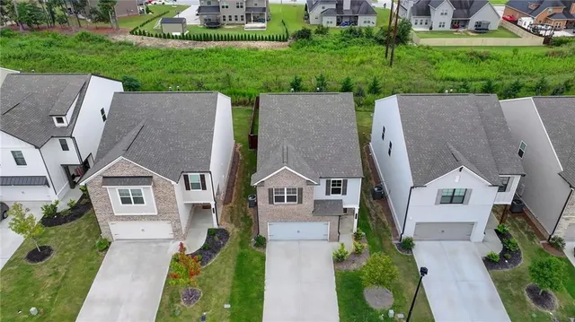 an aerial view of multiple houses with yard